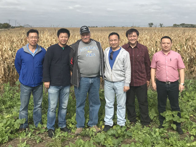 Lewis Barnbridge (wearing ballcap) showed cover crops and explained sustainable farming to a group of Chinese traders who visited his farm in South Dakota. (DTN photo by Lin Tan)