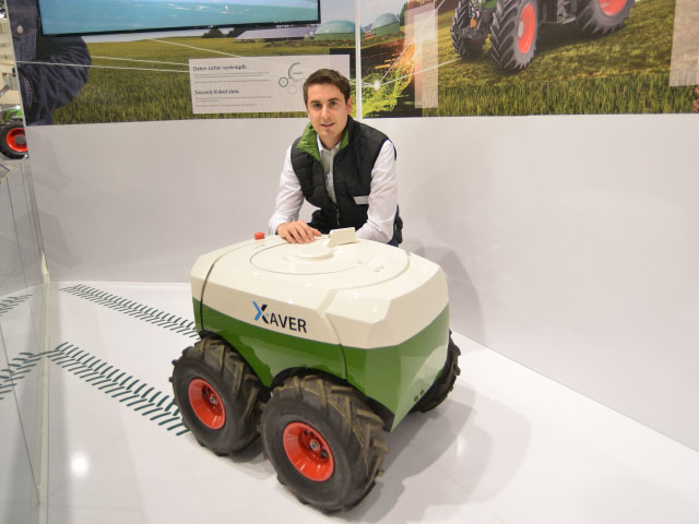 Swarms of mini-robot planters could one day put corn in the ground. Thiemo Buchner, Fendt project developer for robots, displayed a Xaver robot at Agritechnica. Plans are to have the robots in production and for sale in two years. (DTN/The Progressive Farmer photo by Jim Patrico)