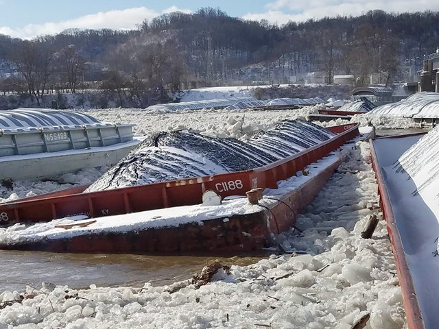 27 or more breakaway barges were lodged at Emsworth Lock and Dam on the Ohio River near Pittsburgh on January 13, closing the river and increasing the risk of localized flooding in the Pittsburgh pool according to the USACE. (Photo courtesy of USACE)
