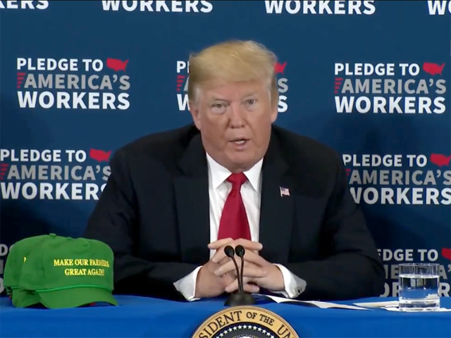 President Donald Trump sits next to ball caps saying "Make Our Farmers Great Again" during a visit to Dubuque, Iowa, on Thursday. A giant aid package, some signs of positive trade talks with Europe and comments on biofuels reflected some of the president&#039;s push to defend his rural base. (Photo from White House video feed)