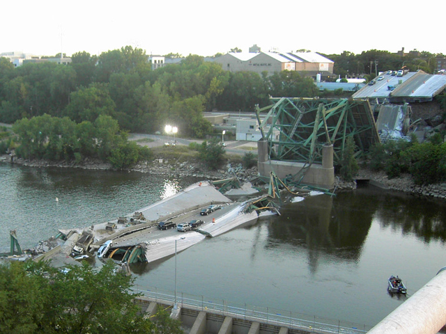 On a bright, sunny evening August 1, 2007, the I-35W Bridge in downtown Minneapolis collapsed during rush hour, killing 13 people and injuring 145. Pictured is the scene on the first morning after its collapse. (Photo courtesy of Mike Wills, via Wikipedia)