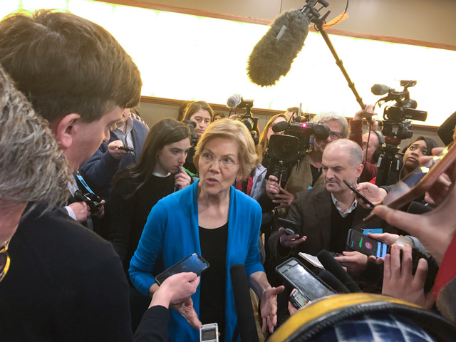 Largely known as an East Coast liberal, Massachusetts Sen. Elizabeth Warren talked heavily about her Oklahoma roots this past weekend in Iowa. She spoke to a throng of reporters after her event Friday night in Council Bluffs. (DTN photo by Chris Clayton)
