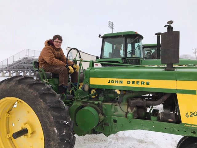 FFA students in Arlington, Nebraska, participated in a National FFA Week event to drive tractors to school on Feb. 19. Shown here is Kyle Quinn on his great grandfather&#039;s 620. FFA members who also drove tractors to school that day were Cassidy Arp, Blake Kracl and Kobe Wilkins. (Photo courtesy of Jill Hensley, Arlington agriculture education/FFA adviser)