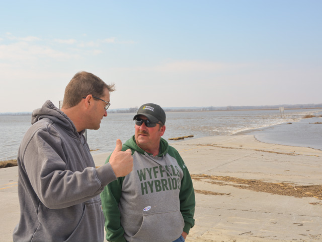 Jeff Jorgenson and Pat Sheldon overlook flood waters that continue to pour over destroyed county highways in Fremont County, Iowa. Water continues to pour in from the Missouri River to most of the river bottom land. (DTN photo by Chris Clayton) 