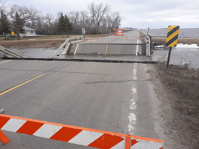 Pictured is a rural bridge crossing a flooded drainage ditch that collapsed due to ice and high water on County Hwy 18 in Norman County, west of Ada, Minnesota. (Photo by Norman County Sheriff&#039;s office)