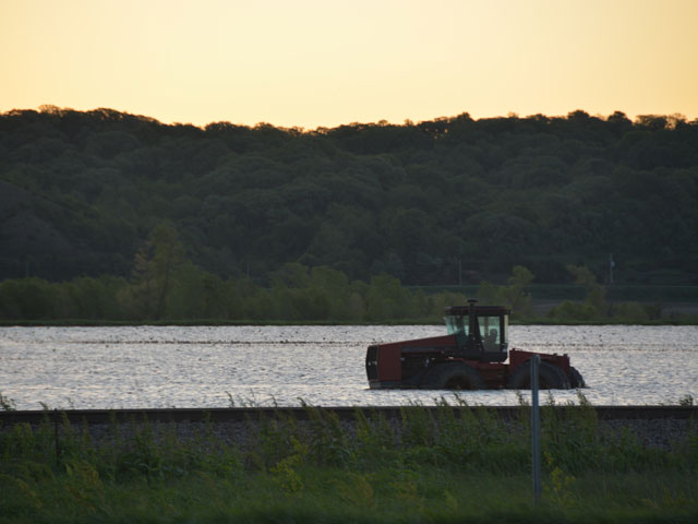 A tractor is surrounded by water near Hamburg, Iowa, as the Missouri River bottoms remain flooded. (DTN photo by Chris Clayton)