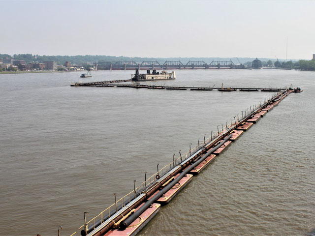 The Dredge Goetz dredges in Pool 16 on the Mississippi River. Flooding turned the Mississippi River into a sandbox after sand and silt were deposited by strong currents and rushing waters created by the barrage of flooding on the entire system. But it will take more than a shovel and bucket to remove this sand. (Picture courtesy of USACE Rock Island.)