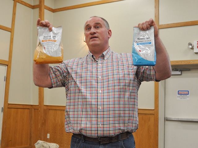 Veterinarian Nate Hansen holds up colostrum replacer during a Southwest Iowa Cow-Calf Short Course held Jan. 27 in Atlantic, Iowa. Improved management at calving time and after a newborn calf is born can often make tough situations go more smoothly. (DTN photo by Russ Quinn)