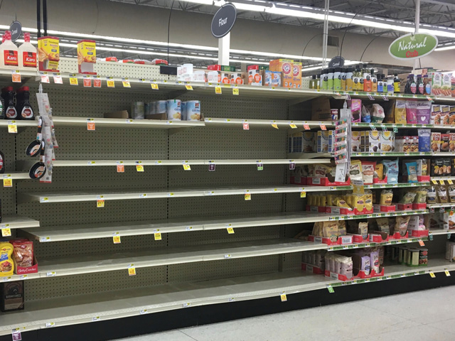 Empty shelves where flour would normally be are becoming the norm at many supermarkets across the U.S. as consumers prepare for a worst-case scenario where fresh bread may hard to source as the coronavirus continues to spread. (Photo by Kelly Moshier)