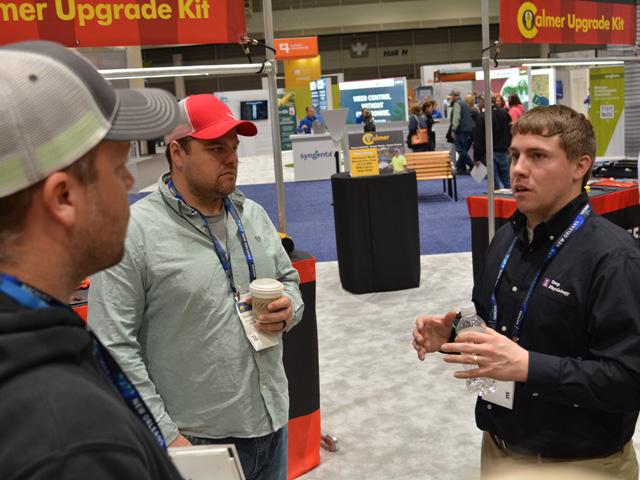 Scott Foxhoven, a University of Illinois graduate student, discusses the pros and cons of banding dry fertilizer prior to planting corn, and possibly in-season, with farmers recently at Commodity Classic in New Orleans. (DTN photo by Matthew Wilde)