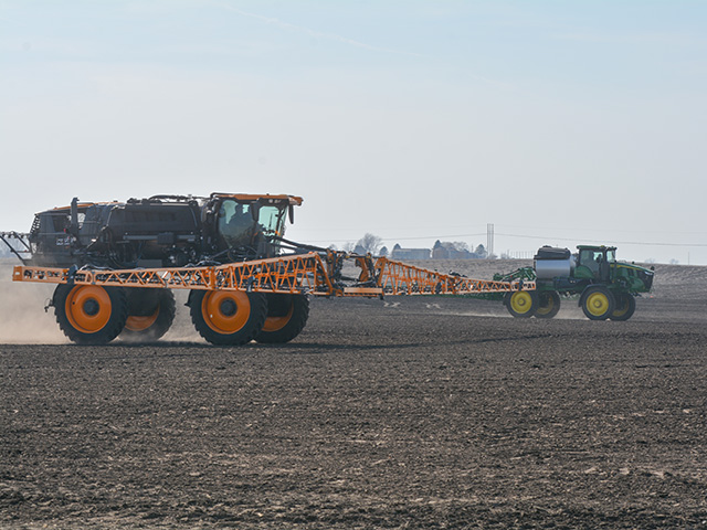 John Deere representatives demonstrated the power and technology of 2022 Hagie STS12 (front) and 2022 John Deere 412R sprayers to ag media on March 9 at the company's ISG Test Farm near Bondurant, Iowa. (DTN photo by Matthew Wilde)