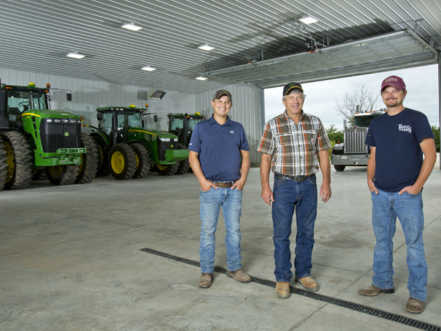 The finished work area measures 72-by-72 feet, accessed by two overhead doors. Just inside one door is a compressor with enough hose to reach any work parked outside on a concrete pad. From left to right: Brad, Gary and Brian Vahle. (Photo by Ted Schurter)