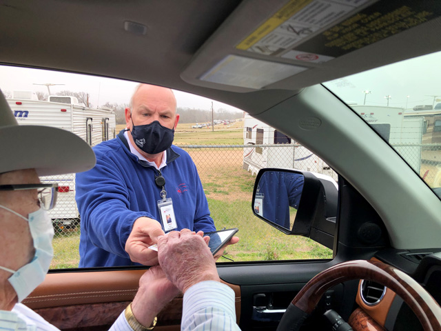 The Biden administration will spend $100 million to boost COVID-19 vaccine outreach efforts in rural areas, especially in states with vaccination rates below the national average. A driver goes through a COVID vaccination in Texas earlier this year (DTN photo by Elaine Thomas) 